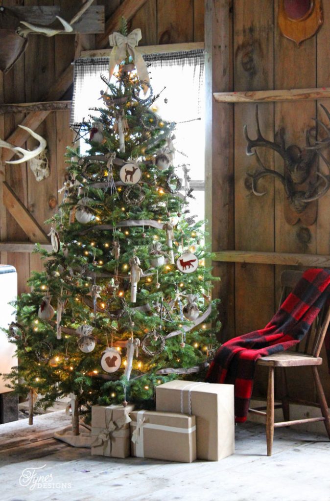 Rustic style Christmas tree and decor in log cabin