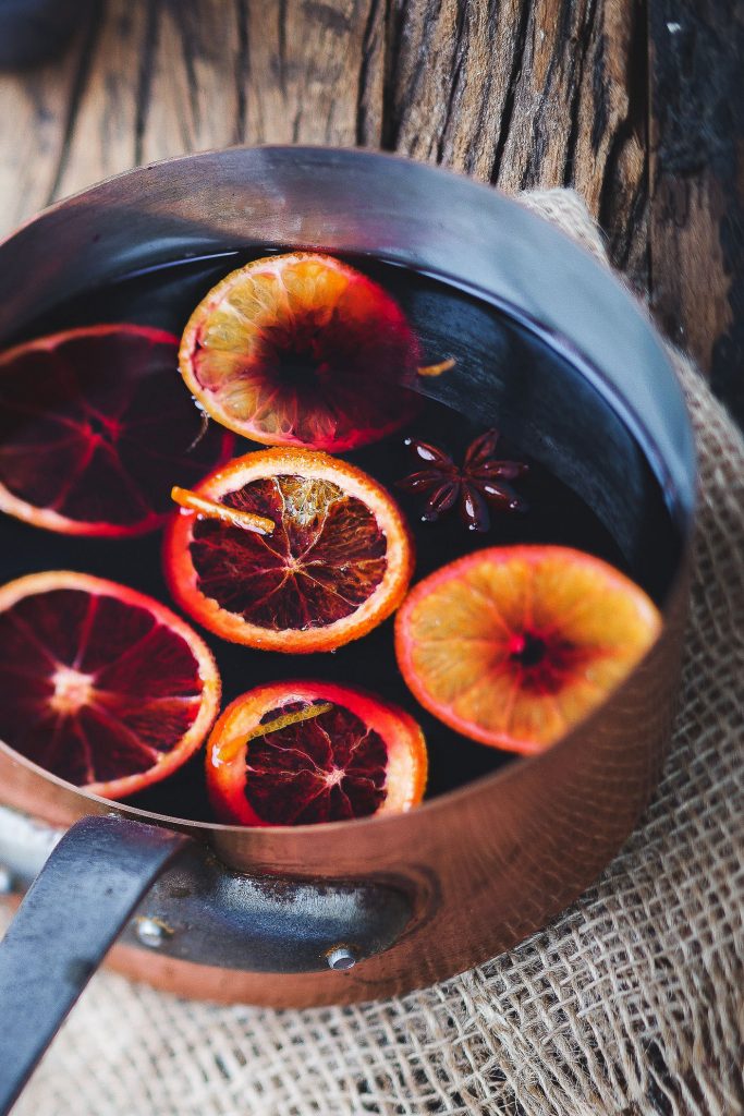 pot of mulled wine with orange slices and star anise